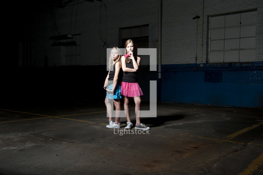 girls posing in an empty warehouse