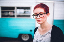 woman with short hair standing in front of an rv