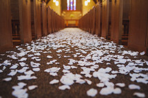 white rose petals spread down the aisle 
