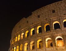 Majestic ancient Colosseum by night in Rome, Italy.