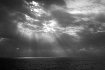 sunlight through the clouds shining onto the ocean 
