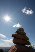 sunburst and stacked rocks