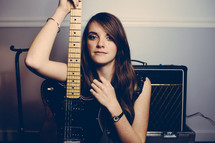 woman holding an electric guitar 