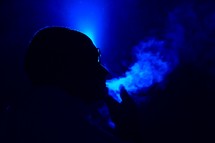 a man blowing smoke