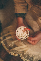 girl holding a mug of hot cocoa 