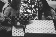 women opening Christmas gifts 