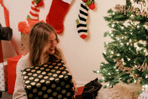 woman holding a large wrapped Christmas gift 