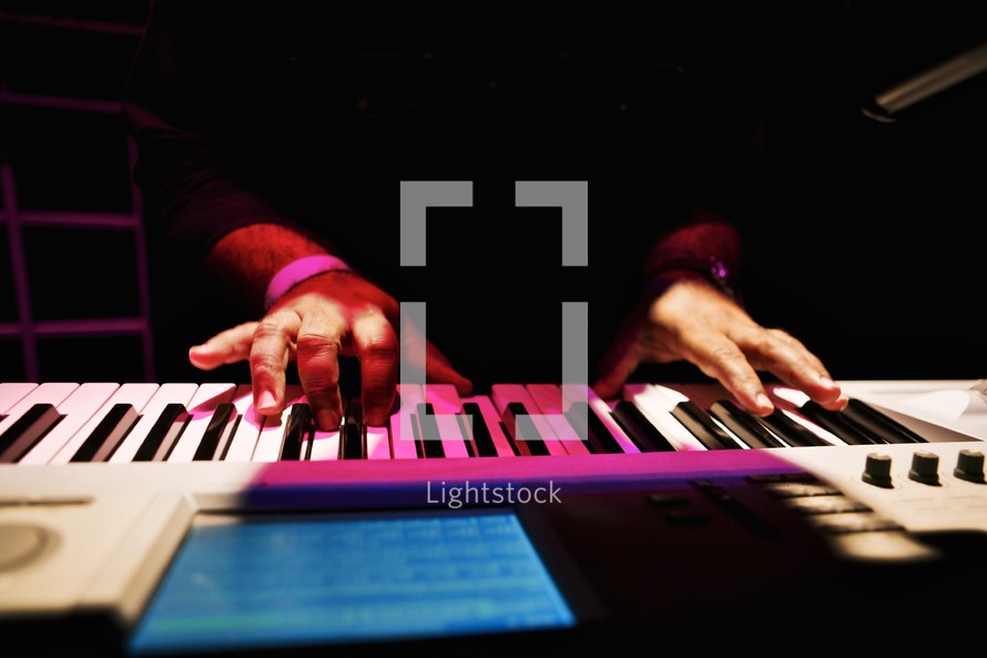 Male hands playing keyboard