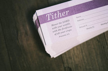tithes and offering envelopes stacked