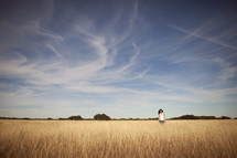 Woman on dry wheat field 