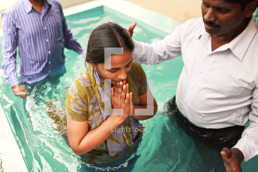 Man baptizing woman