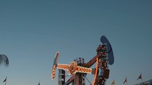 People on a ride at an amusement park in the evening (multiple shots)