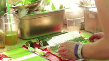 a woman making sushi 