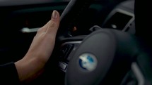 a woman's hands on a steering wheel 