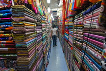 A fabric store filled with multiple colored and textured fabrics