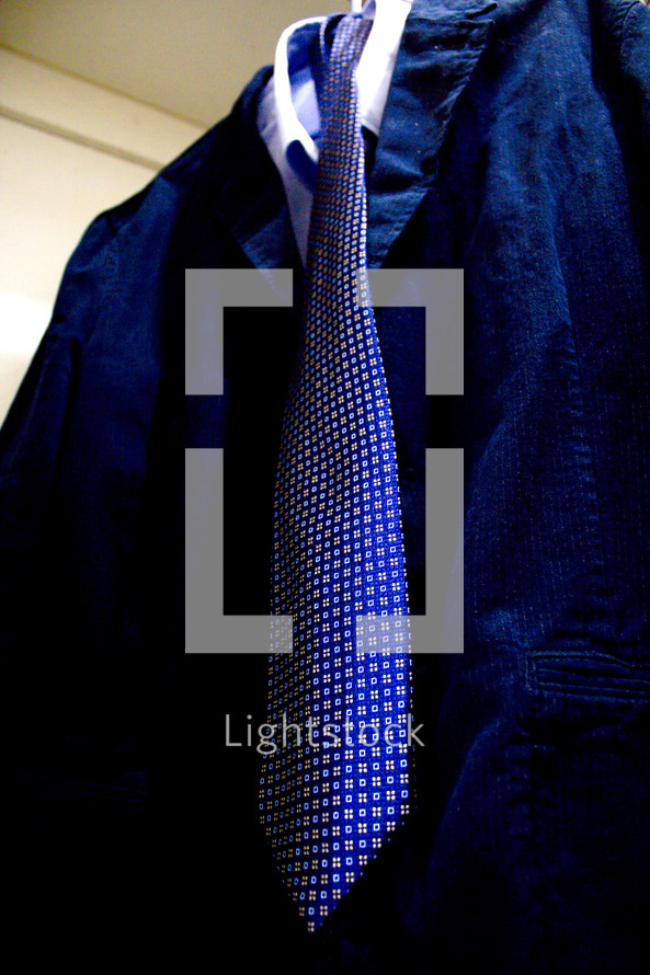 tie and suit on a hanger