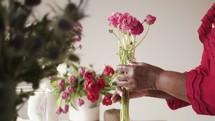 a woman arranging flowers for mother's day 