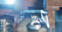 Close up shot of a punch press forming metal parts