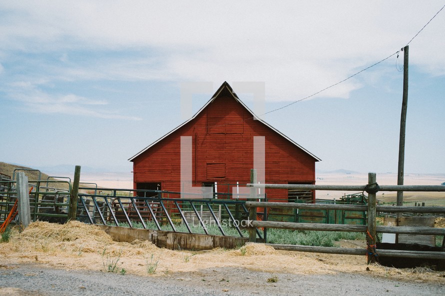 red barn and feeding area and fence 