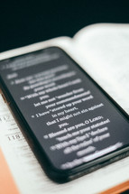 BIble app on a cellphone on the pages of a Bible 