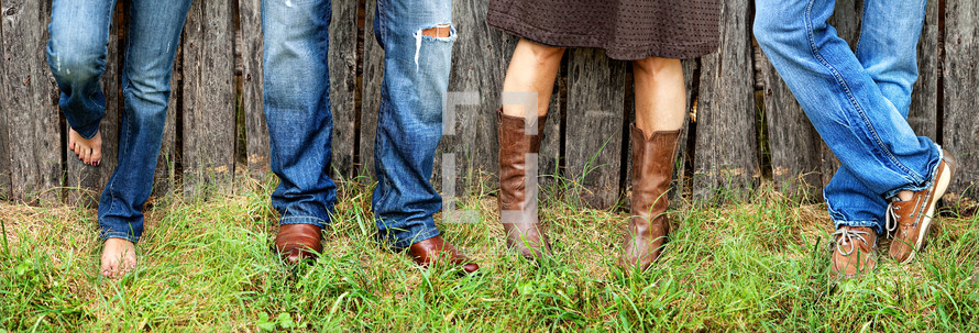 A family wearing blue jeans and cowboy boots 