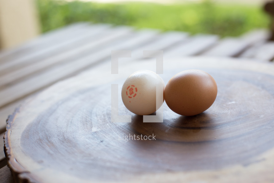 two eggs on a cutting board 