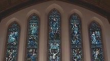 stained glass windows above a church altar 