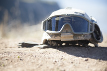 soldiers helmet and goggles on the ground