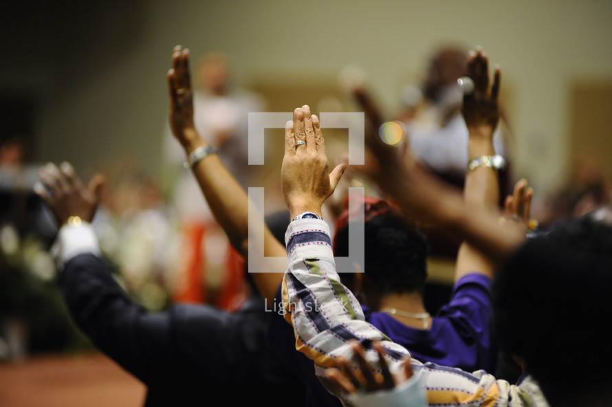 Raised hands during a worship service.