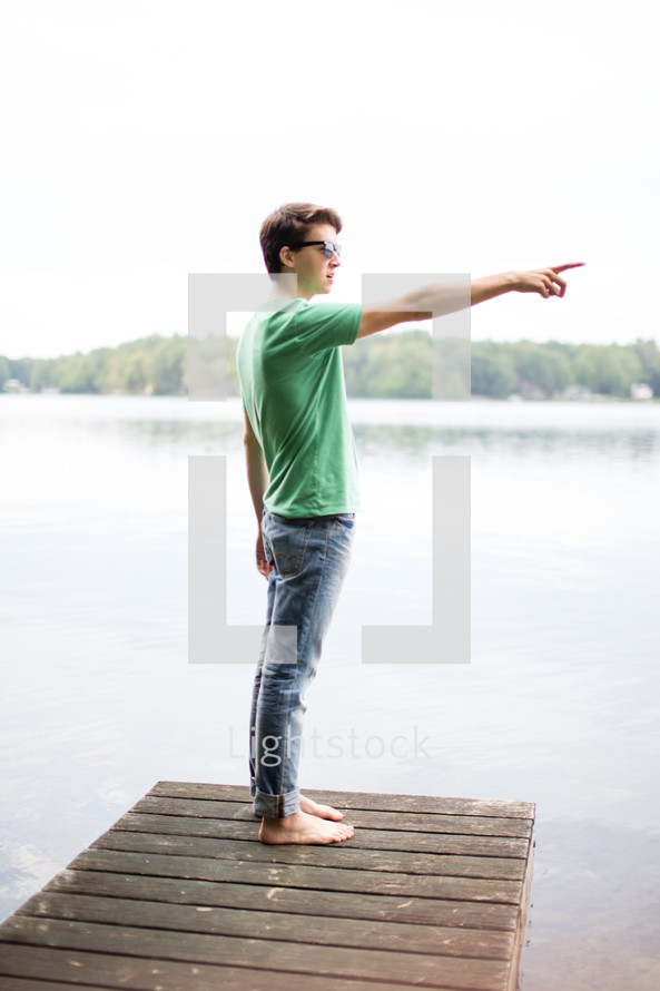 man on a dock pointing 