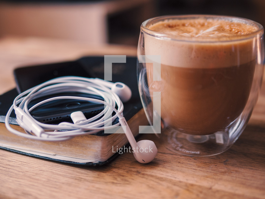 coffee and Bible with earbuds 