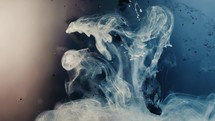Slow motion shot of black and blue paint ink exploding blast underwater,close up	