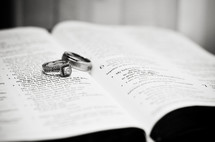 wedding rings on pages of a Bible