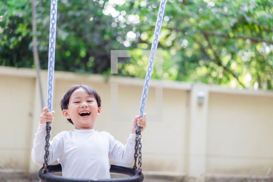 a happy child on a swing 