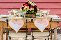 A rustic  table setting for a bride and groom wedding decor table setting hearts
