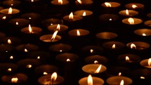 votive prayer candles in the darkness of a church