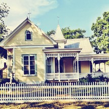Yellow house and white picket fence