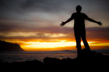 Man standing on beach watching sunset - God is my salvation