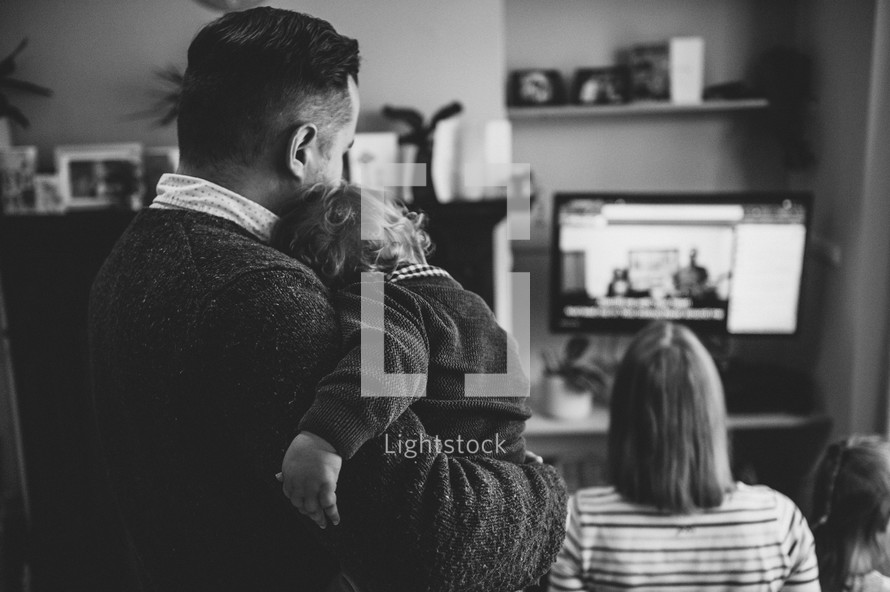 family watching a worship service at home 