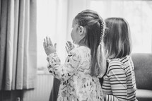 mother and daughter clapping watching a online worship service 