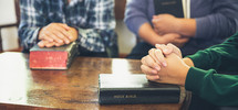Group of Asian people meeting and praying with Bibles