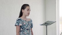 child singing during a worship service 