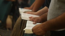 Bible reading from Bibles during a worship service 