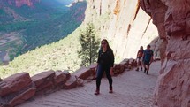 A group of hikers walking up to the top of  Angel's landing in Zion National Park
