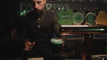 Barman Serves Mug Of Green Beer