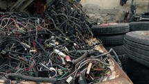 Electrical cables to be recycled piled up in landfill. 