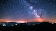 Dark sky in starry night with milky way galaxy stars in summer alps mountains Astronomy Time lapse Night to day