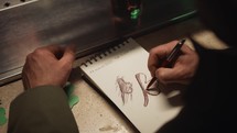 Drawing a clover in the notebook