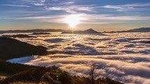 Peaceful Sunny evening in mountains nature with foggy clouds flows in autumn valley landscape at sunset Time lapse
