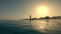 Man on stand up Paddle at sunrise 